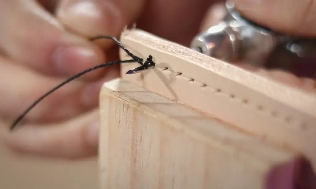 How do you finish a stitch on a leather awl?