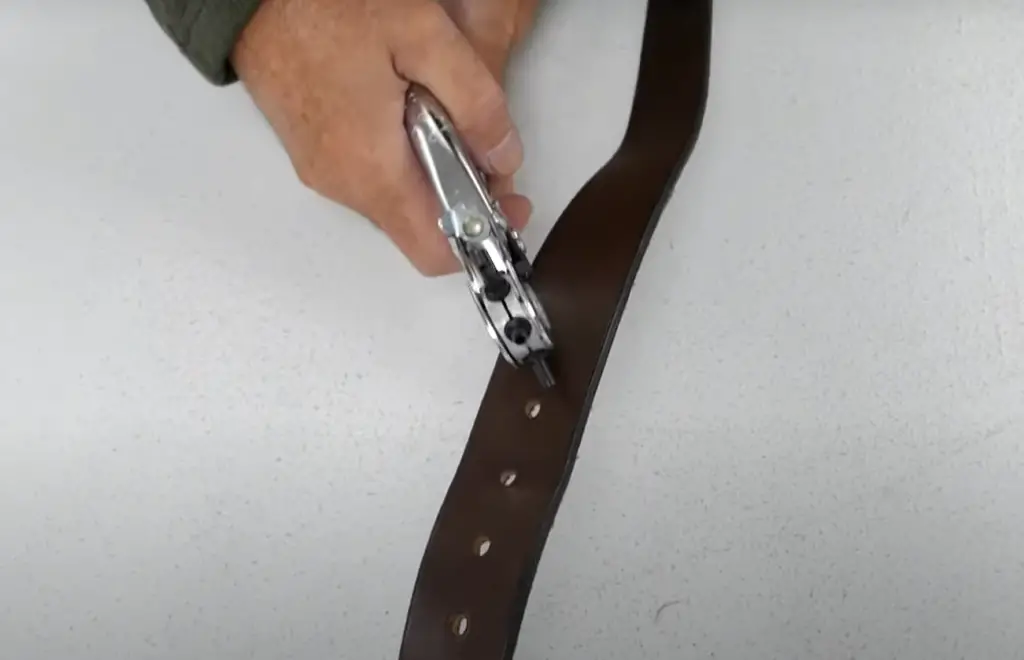 How do you poke a hole in a leather belt?