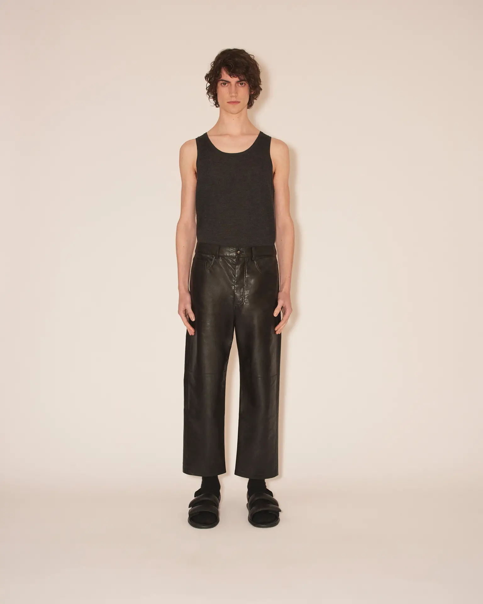 Black leather pants with a black sleeveless crop top