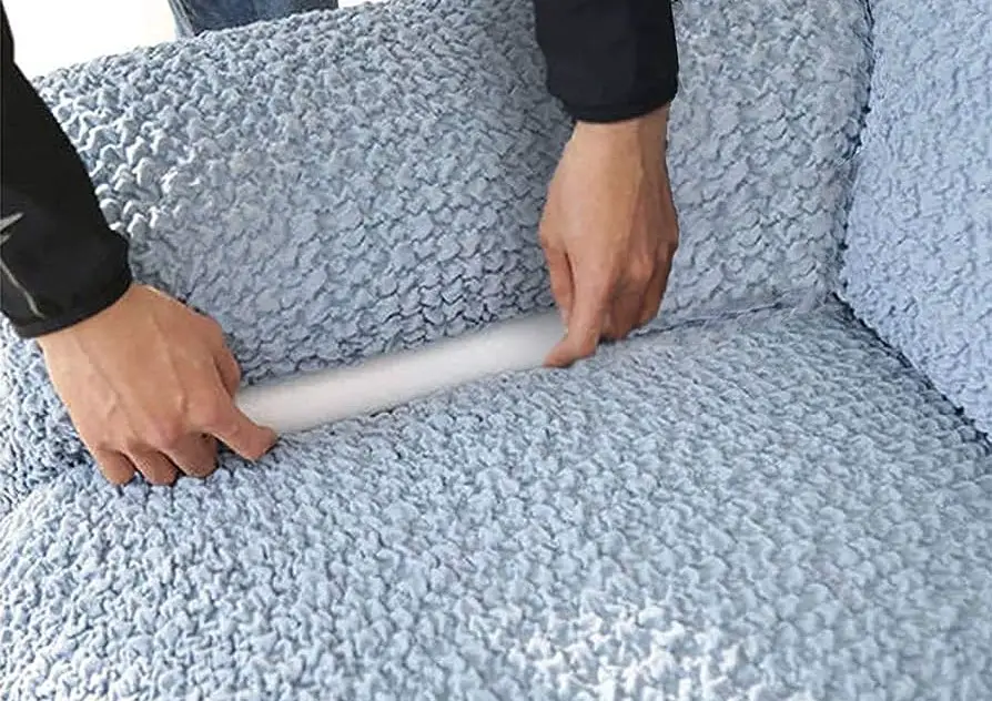 Secure the sofa cover using tuckers, grips, or inserts